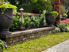 RAISED PLANTERS WITH DECORATIVE PAVERS